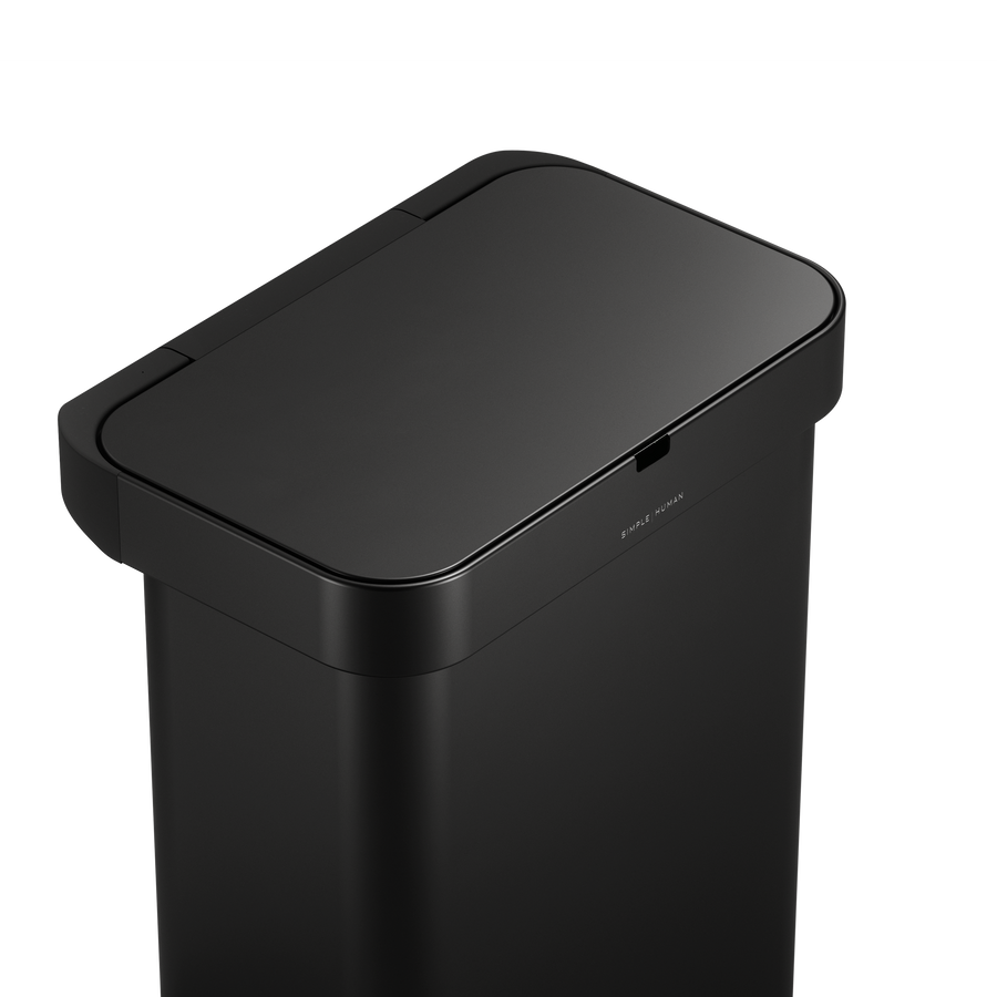 Detail view of Simplehuman 58L Sensor Can Matte Black top surface, showing touch-free sensor.