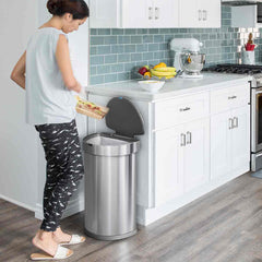 45L semi-round sensor can - brushed finish - lifestyle woman scraping off food in kitchen