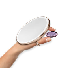 sensor mirror compact 3x - rose gold finish - hand holding makeup image